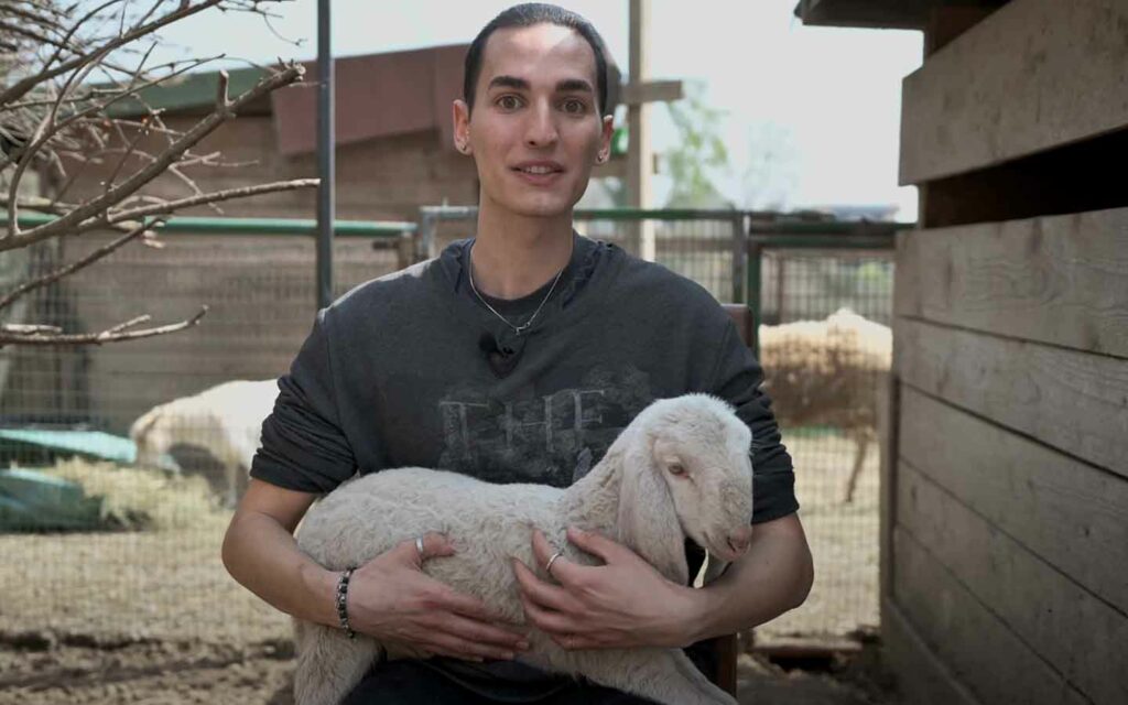 Andrea Capodanno holding a lamb
