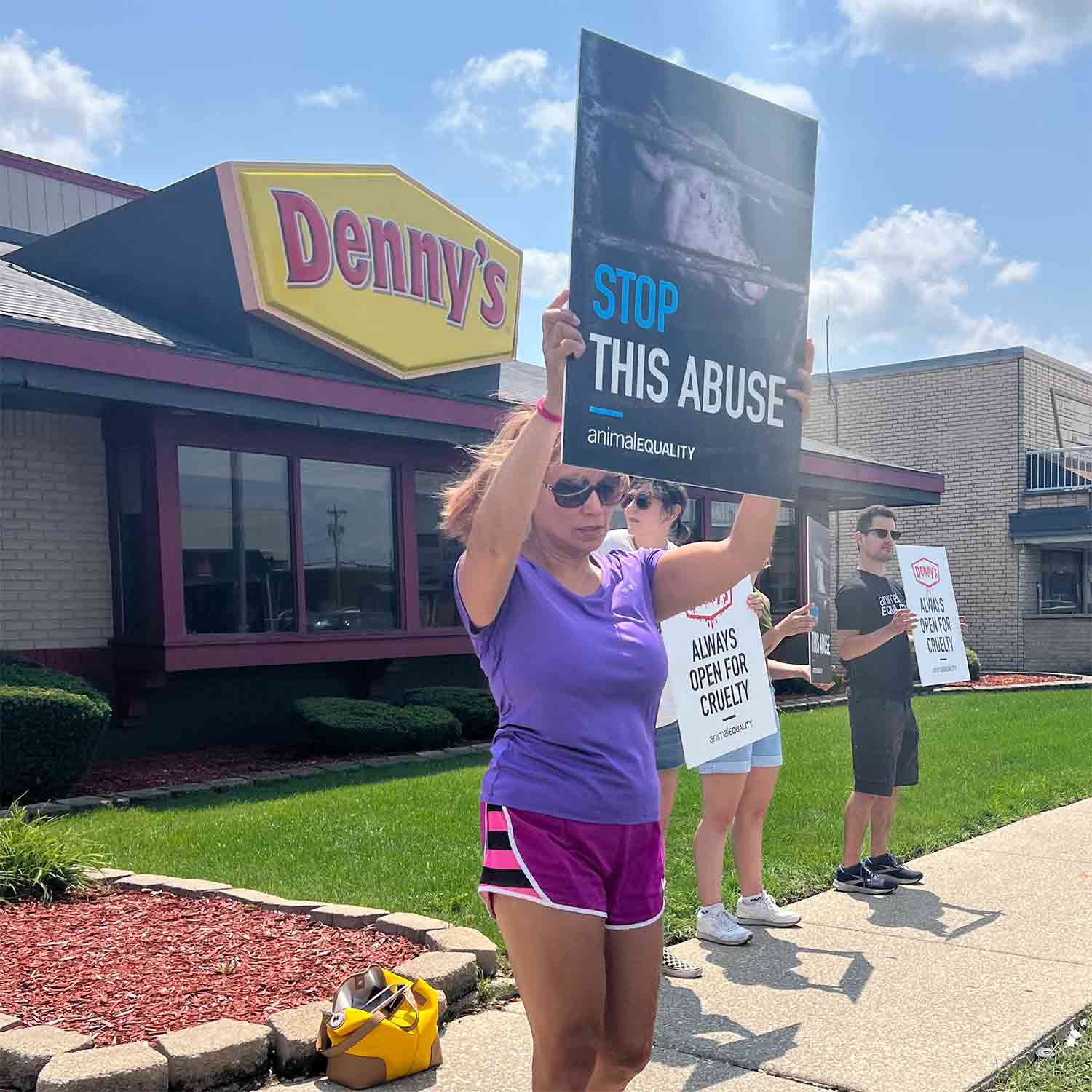 Protestor holding sign at Denny's in Chicago