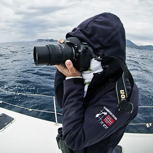 Investigator holding a camera in the sea