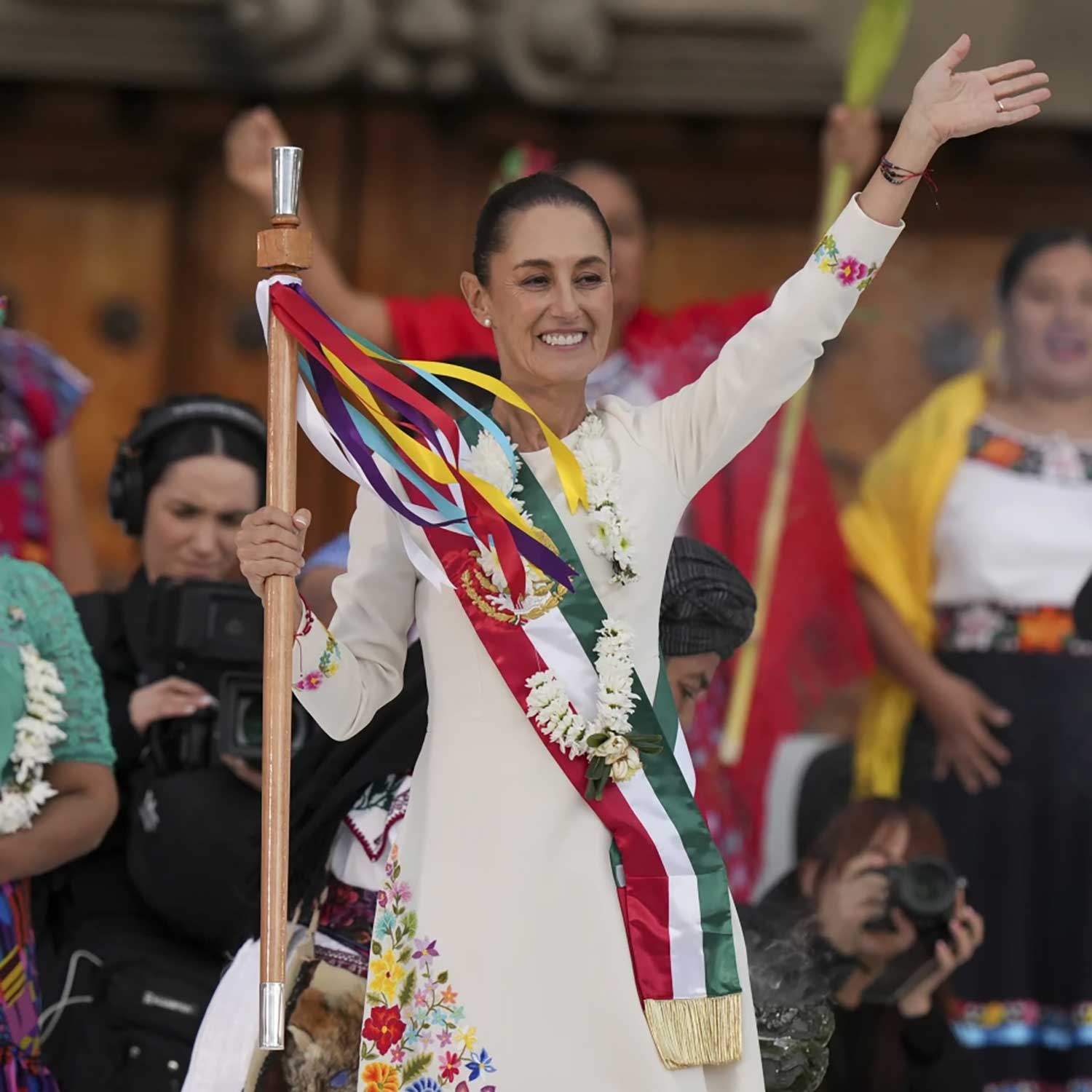 President Claudia Sheinbaum waves to supporters in the Zócalo, Mexico City's main square, during a rally on her inauguration day, Tuesday, Oct. 1, 2024. (AP Photo/Fernando Llano)