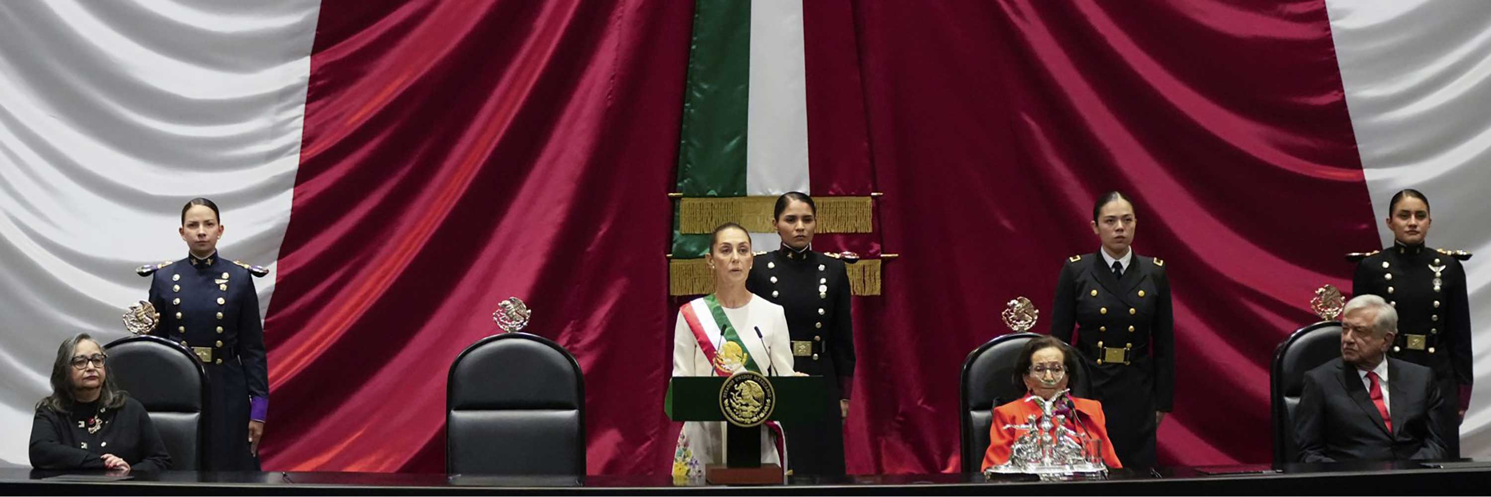 President Claudia Sheinbaum, center, and outgoing President Andres Manuel López Obrador, right, stand before lawmakers on her inauguration day at Congress in Mexico City, Tuesday, Oct. 1, 2024. (AP Photo/Eduardo Verdugo)