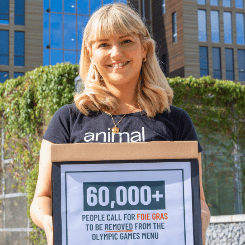 Primer Reporte de Impacto 2026 6 Abigail Penny holds up a box of petition signatures against foie gras.