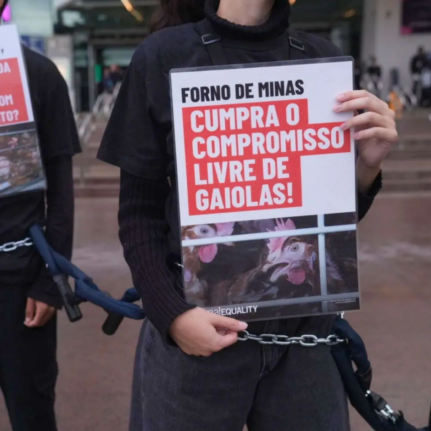 Animal Equality activists chain themselves together in protest outside a McCain and Forno de Minas location in Brazil