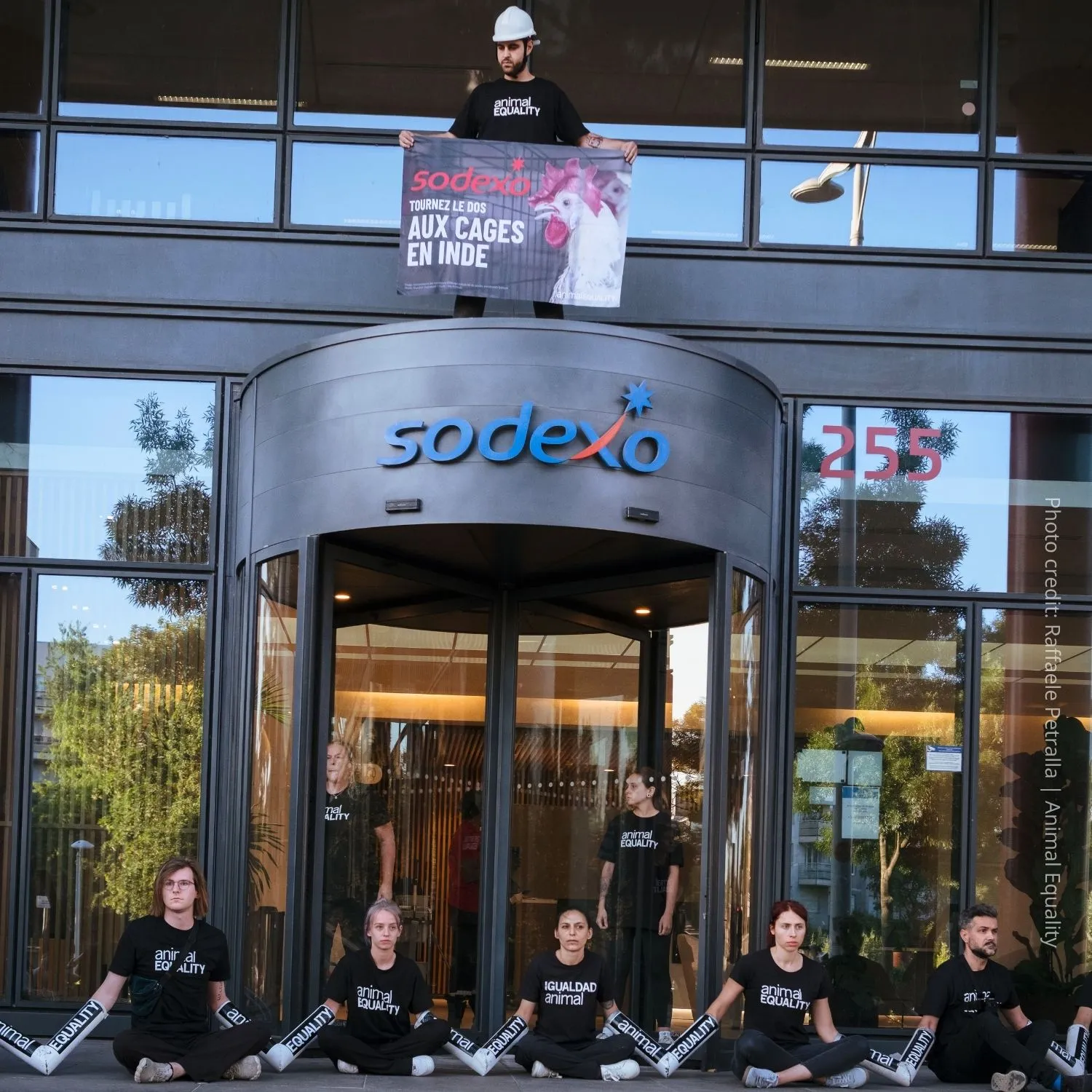 Activists chained to the Sodexo headquarters in Paris, France.