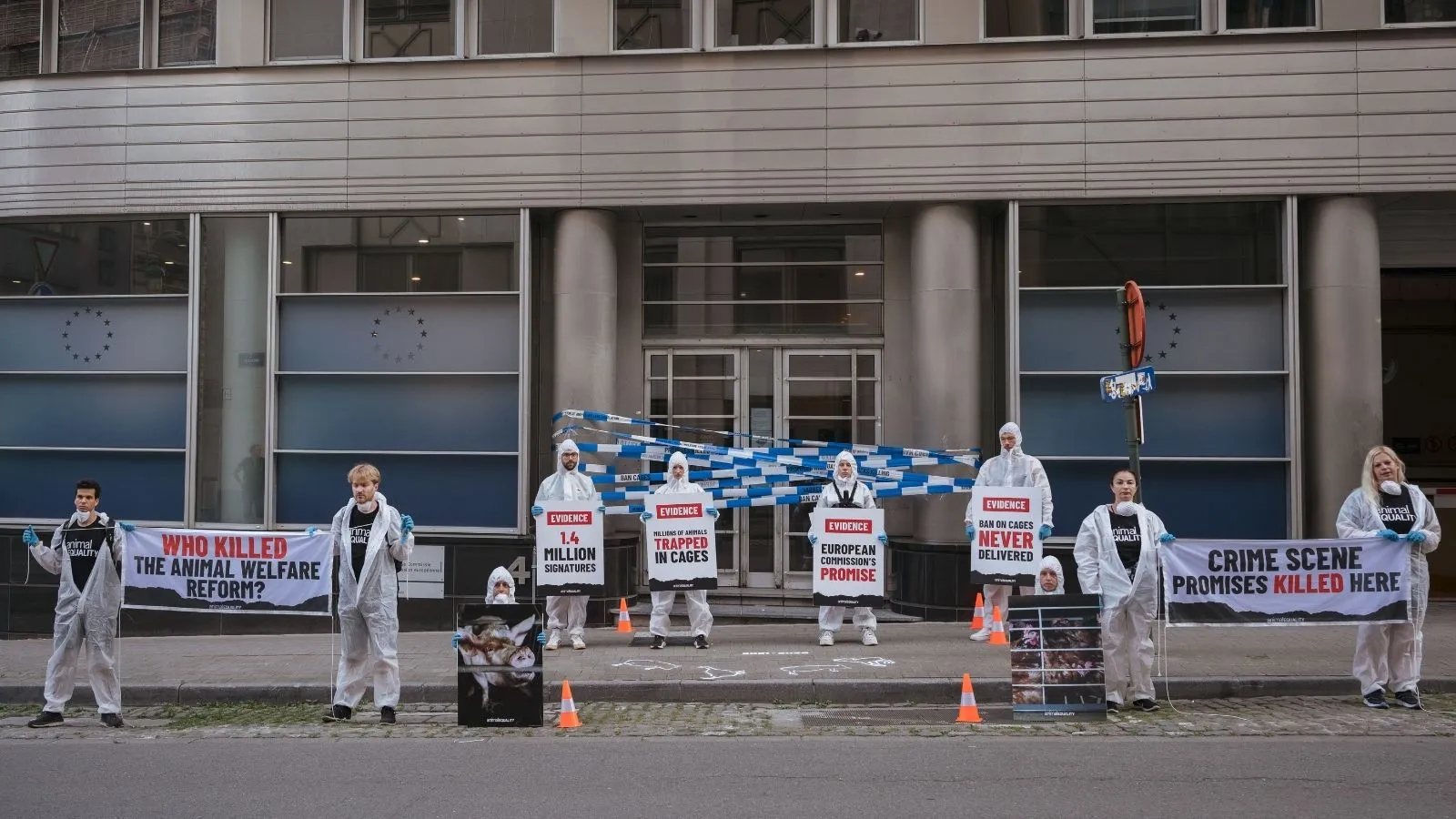 Animal activists hold signs urging the EU for animal protections.
