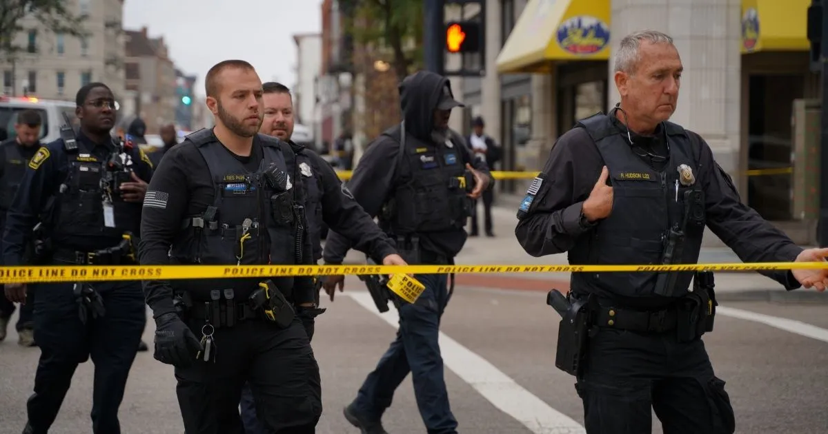 Police officers approach Animal Equality activists chained to the entrance of Kroger's headquarters in Cincinnati, Ohio.